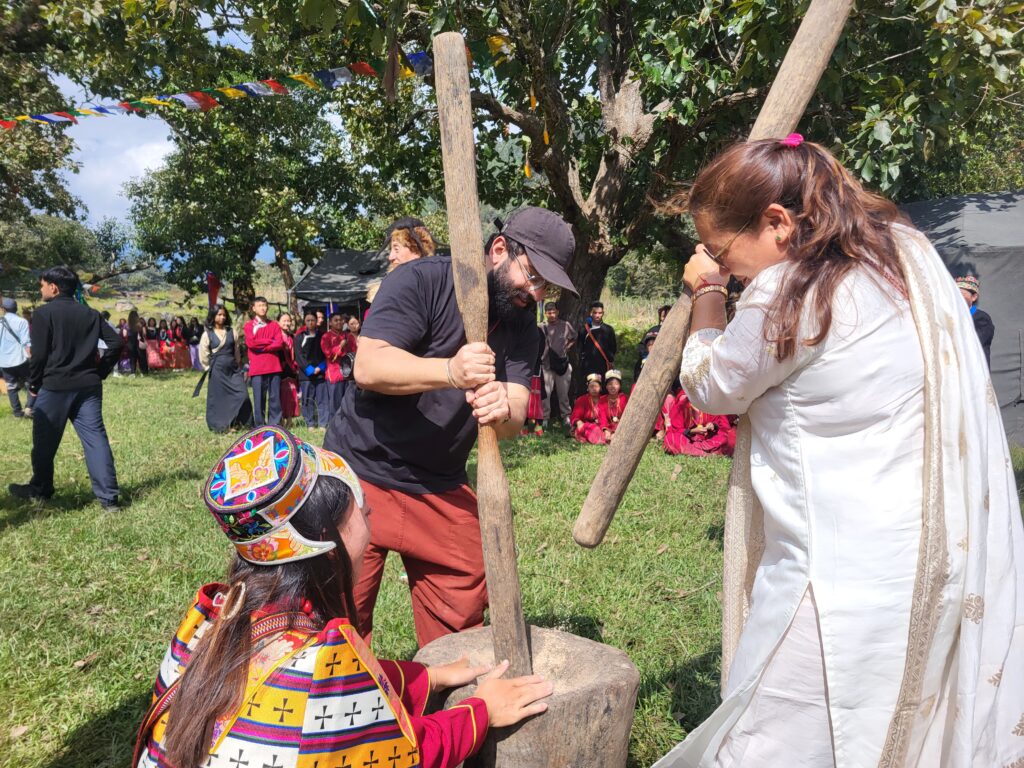 Traditional rice pounding at Chug valley. visitors enjoying tales of Northeast